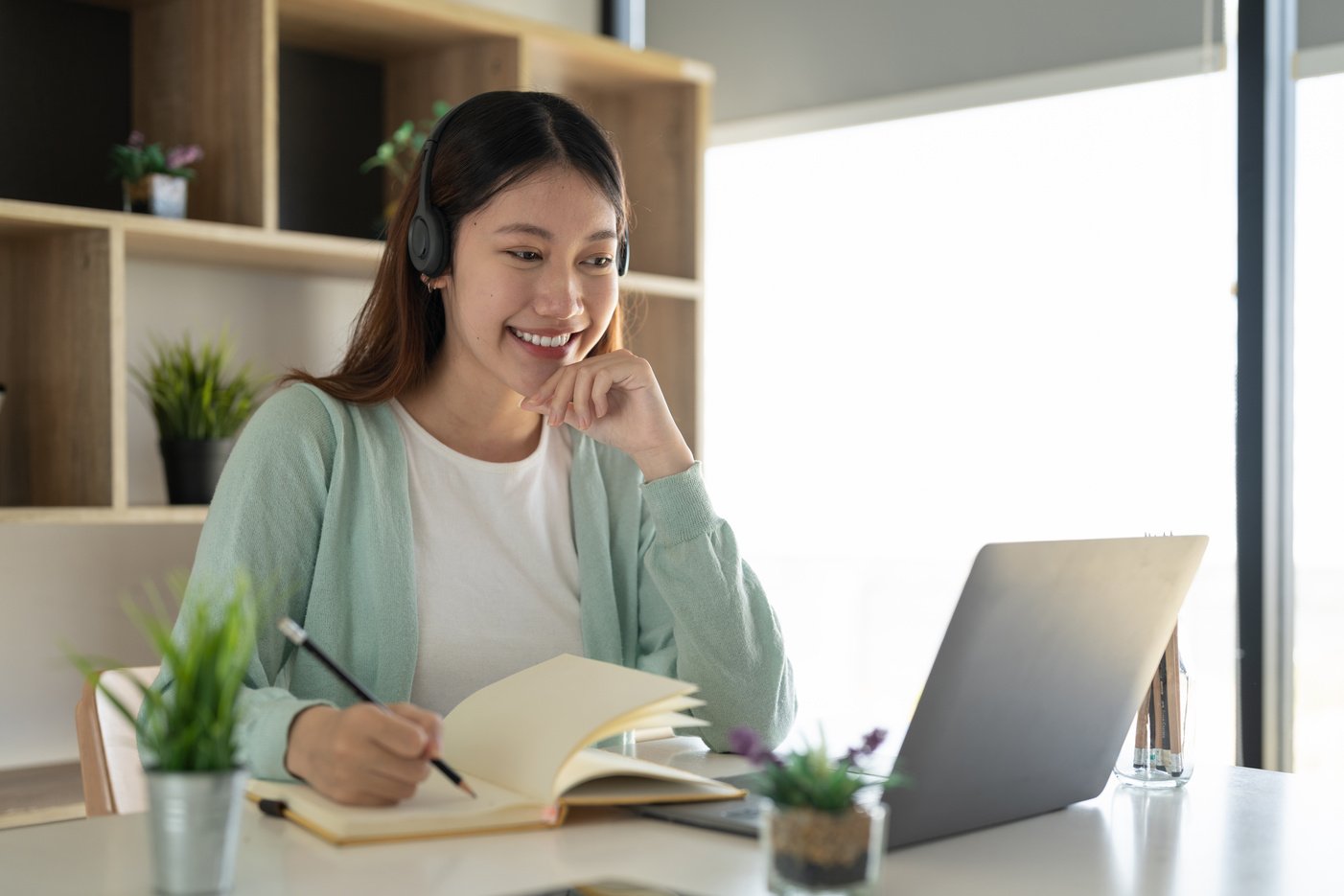 Concentrate asian gial freelancer wearing headset, communica